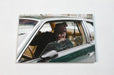 Custom 14pt uncoated matte postcard with a photographic print of an African American man sitting inside a vintage car on a white background