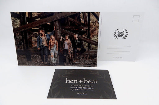 Custom 14pt uncoated matte postcards featuring photographic prints and hen+bear branding on a white background