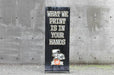 Straight-on front view of a 24x60 outdoor X banner stand with custom printed black vinyl artwork. Clubcard Printing USA