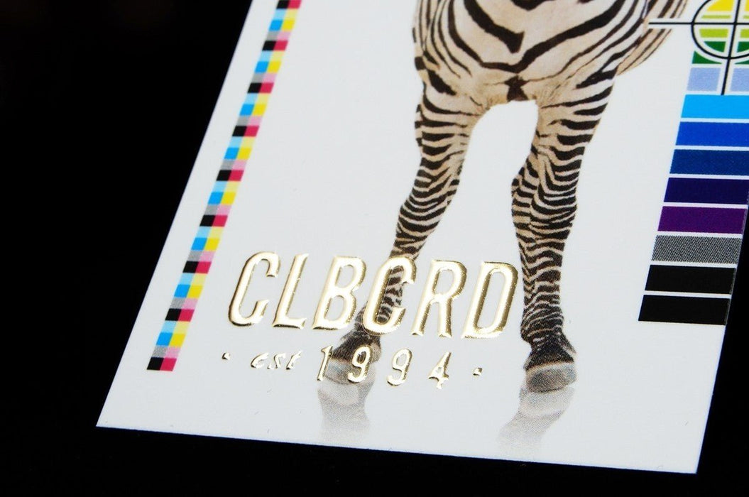 Close-up of Clubcard sample card on 19pt suede stock featuring CLUBCARD logo and and small text in raised gold metallic foil