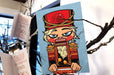 Nutcracker holiday greeting card sample on 19pt suede stock featuring 3D raised metallic foil accents 