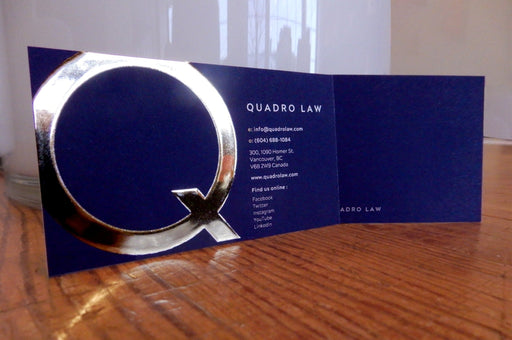 Raised gold foil business cards printed on 19pt suede laminated card stock with letter Q in raised gold metallic