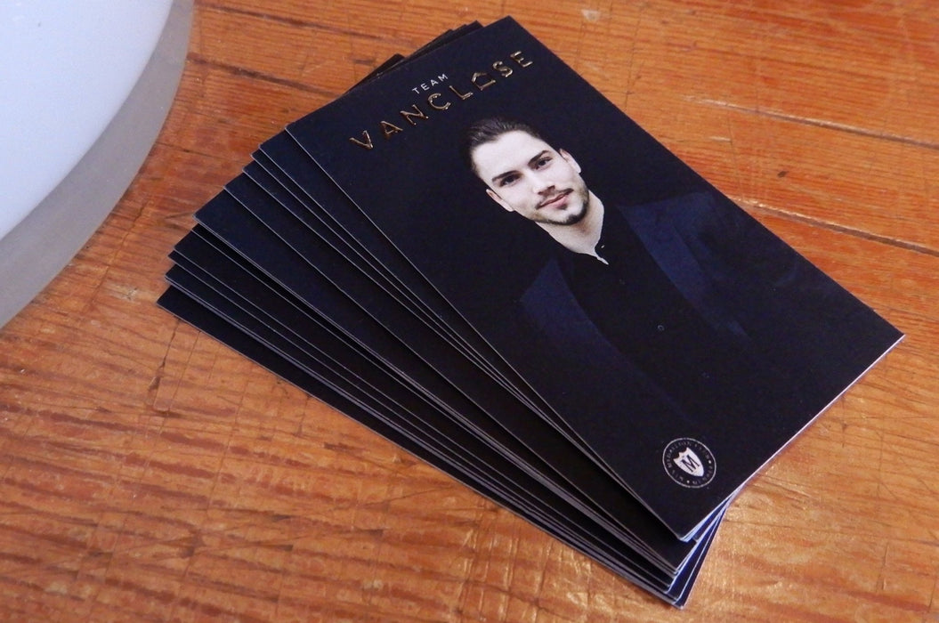 Raised silver foil business cards printed on 19pt suede stock with logo in raised silver metallic