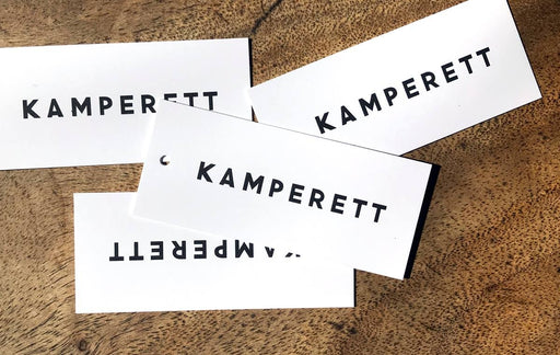Uncoated 22pt custom hang tags make an elegant statement.  priinted for Kamperett.