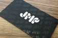 Custom business cards for JMP on Color Core Silk Business Cards 40pt | White JMP logo on a black background with the same logo as a pattern in spot gloss | Clubcard Printing USA