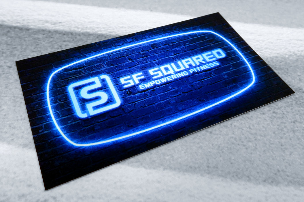 Custom printed business cards printed for SF Squared on out 20pt Soft Touch Laminated stock | Their logo designed as a blue neon sign on a brick wall | Clubcard Printing USA