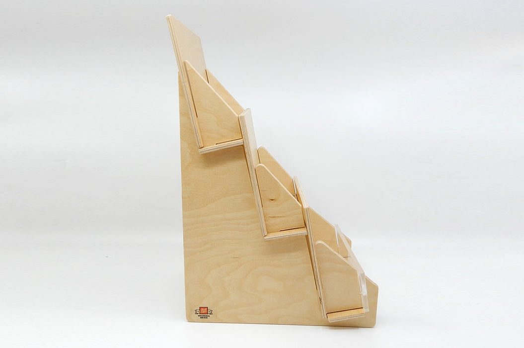 Side of a slim birch plywood 3-tier display card stand with Clubcard logo at the bottom.